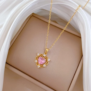 Gold titanium necklace featuring a pink heart stone and sparkling clear zircons on silk