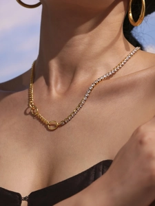 Detail of gold double-layered tennis chain necklace with dancing girl pendant
