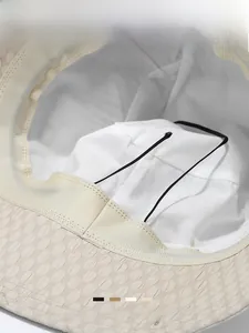 Detailed view of the woven texture and black windproof strap on a sun bucket hat