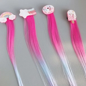 Detailed view of colorful hair clips with long synthetic wig extensions for young girls