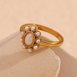 Detailed close-up of a vintage 18K gold plated ring with oval pearl and zircon accents