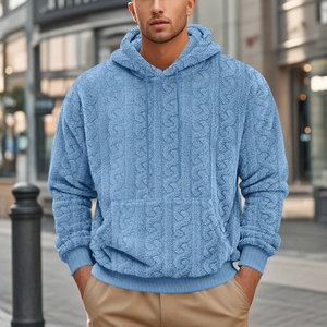 Detail of light blue teddy fleece hoodie featuring textured cable knit pattern and drawstrings