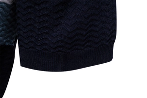Close-up of navy blue men's polo showing premium wave knit texture and ribbed hem