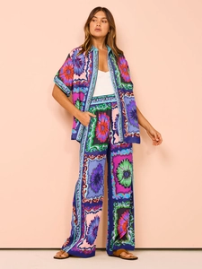 Detailed pattern view of colorful bohemian floral print on summer wide-leg trouser set