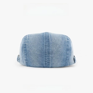 Detailed view of light blue denim flat cap showing the twill fabric texture and side buckle