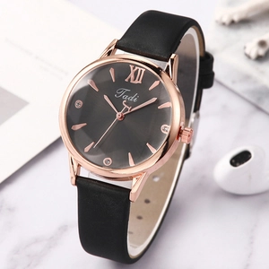 Close-up of elegant women's quartz watch featuring Roman numerals and rhinestones detail