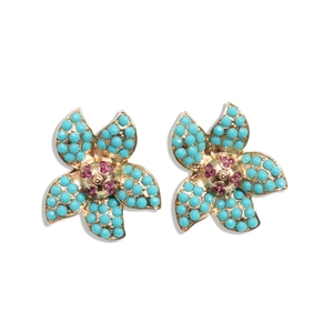 Ethnic gold flower earrings with turquoise beads and pink crystal center on white background