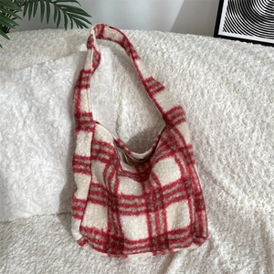 Detail of red and white plaid fuzzy tote bag made of thick warm faux shearling material