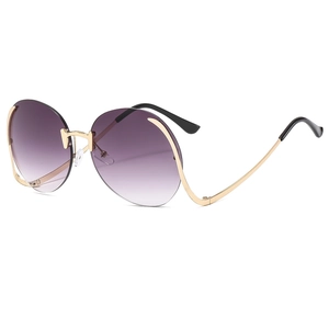 Frameless oversized sunglasses with purple gradient lenses and gold metal frame from side view