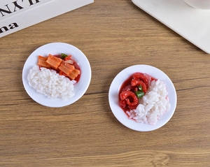Macro shot of realistic miniature PVC rice bowls with spicy octopus on wooden table