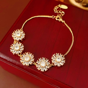 Detail of gold-plated sunflower bracelet with clear zircons on premium wood box