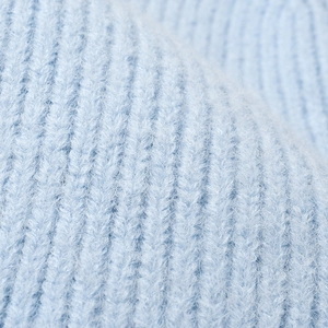 Thick light blue ribbed knit beanie fabric texture with soft warm thermal fleece fibers