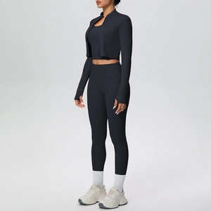 Detail of high-waisted yoga pants and zip jacket with thumbholes in matte black