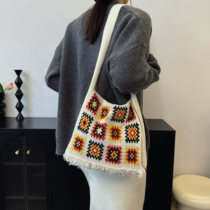 Bohemian granny square knit tote bag with colorful geometric patterns and fringe detail