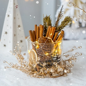 Christmas diffuser set with cinnamon, pine cones, and LED lights in glass bottle