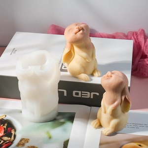 Detailed view of the flexible white silicone Easter bunny candle mold with a finished rabbit