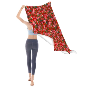 Close-up of the large red microfiber beach towel featuring traditional peony floral patterns