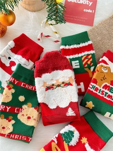 Flat lay of festive combed cotton Christmas socks featuring Santa and gingerbread motifs