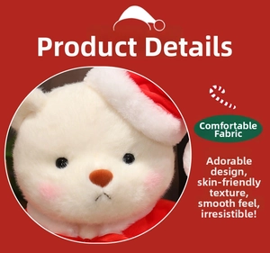 Close-up of white plush Christmas teddy bear featuring red hat, scarf and soft fabric detail