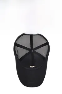Detail of breathable black mesh panel and golden metal emblem inside the baseball cap
