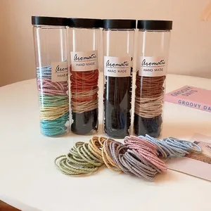 Elastic hair ties set in Morandi colors and cylindrical jars with handmade labels