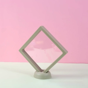 Detail view of the PE film floating jewelry box with a round base in light sage green