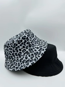 Close-up of leopard print and solid black reversible fisherman bucket hats for sun protection
