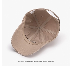 Detail view of khaki cotton baseball cap interior with 1994 embroidery and metal buckle