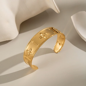 Modern 18K gold plated stainless steel open cuff bracelet with embossed floral patterns