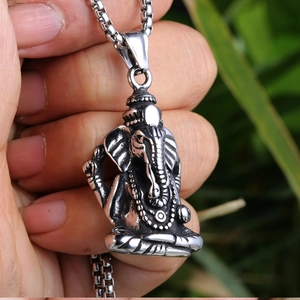 Close-up of a silver Ganesha elephant pendant on a stainless steel chain for men