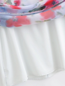 Close-up of floral chiffon dress showing pink print fabric with white inner lining