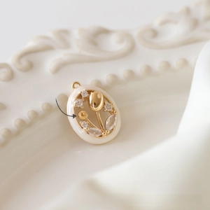 Macro detail of tulip pendant with crystal accents and round base for DIY bead attachment