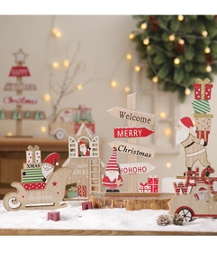 Close-up of wooden Christmas decor with Welcome sign and Santa Claus on a festive table
