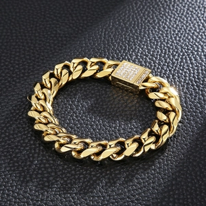Close-up of gold-plated Cuban link bracelet with white zircon encrusted clasp on leather
