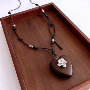 Vintage heart wooden pendant necklace with silver flower inlay on a leather cord