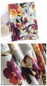 Detail view showing butterfly floral print and texture of warm cashmere-like scarf