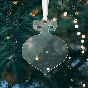 Clear acrylic Christmas ornament with ribbon hanging on a festive tree branch