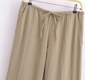 Detail view of khaki cotton linen wide-leg pants with drawstring waist and side pockets