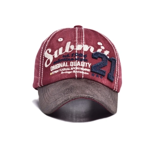 Detailed view of burgundy canvas baseball cap with white Submit embroidery and blue patch