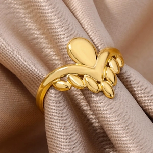 Macro detail of 18k gold plated V-shaped crown ring with leaf design on silk