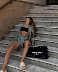 Detail of printed grey-green shirt and high-waist drawstring shorts casual set