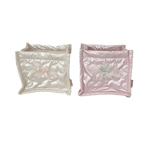 Square quilted organizers in cream and pink with heart patterns and decorative bows
