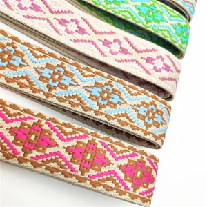 Detailed view of woven bohemian bag straps with colorful geometric jacquard patterns