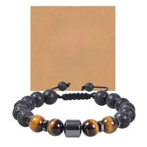 Close-up of 10mm lava and tiger eye stone bracelet with a greeting card for gift giving