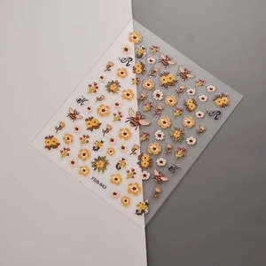 Macro detail of floral and bee 3D nail stickers FEB-843 with yellow flower patterns