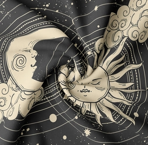 Detailed close-up of soft sun and moon tapestry fabric showing stars and celestial textures