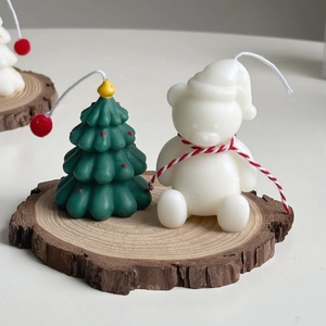 Mini hand-painted Christmas tree and polar bear candles on a rustic wooden base