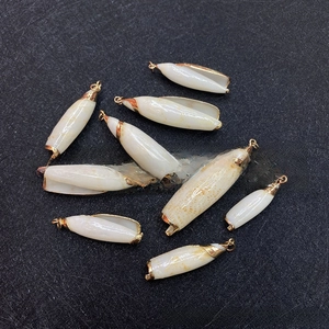 Detailed view of nine natural white seashell pendants with elegant gold-plated metal edges