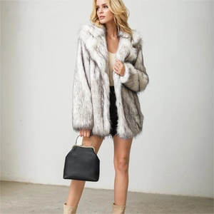 Close-up of fluffy faux fur texture on black and white gradient long coat for women