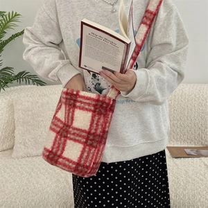 Detail of red and white checkered plush shoulder bag on model for autumn fashion styling